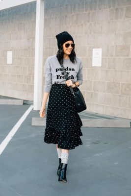An embroidery sweatshirt paired with a skirt and ankle boots